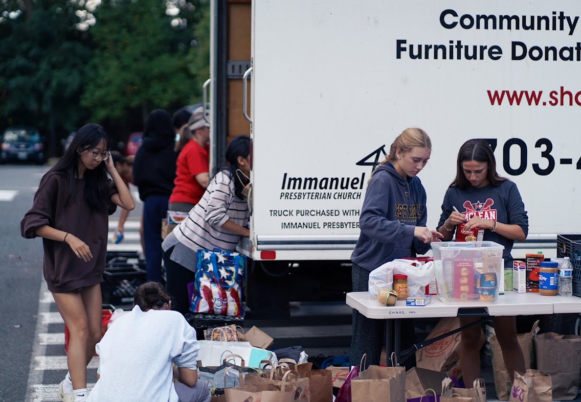 Volunteers sort and pack donated goods outside Temple Rodef Shalom during TeensForFoodBanks’ Yom Kippur food drive.