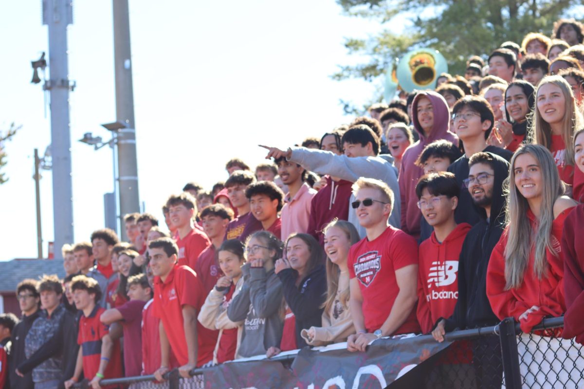 Seniors cheer as students and McLean staff play tug of war.