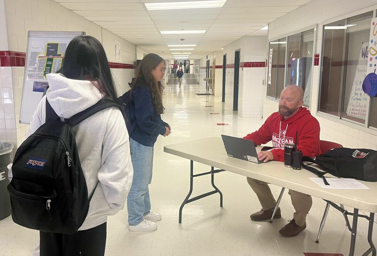 Assistant principal Zachary Winfrey oversees student movement during lunch. Students lined up to receive passes for the library or informed Winfrey of their next destination. 