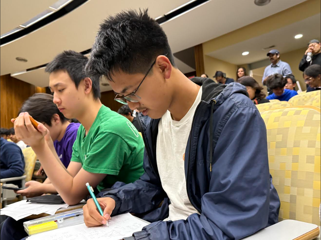 Senior Kalan Warusa solves geometry problems during the annual Duke Math Meet. After fulfilling all of his high school credits this year, Warusa is set to graduate as part of the class of 2026 this summer. 