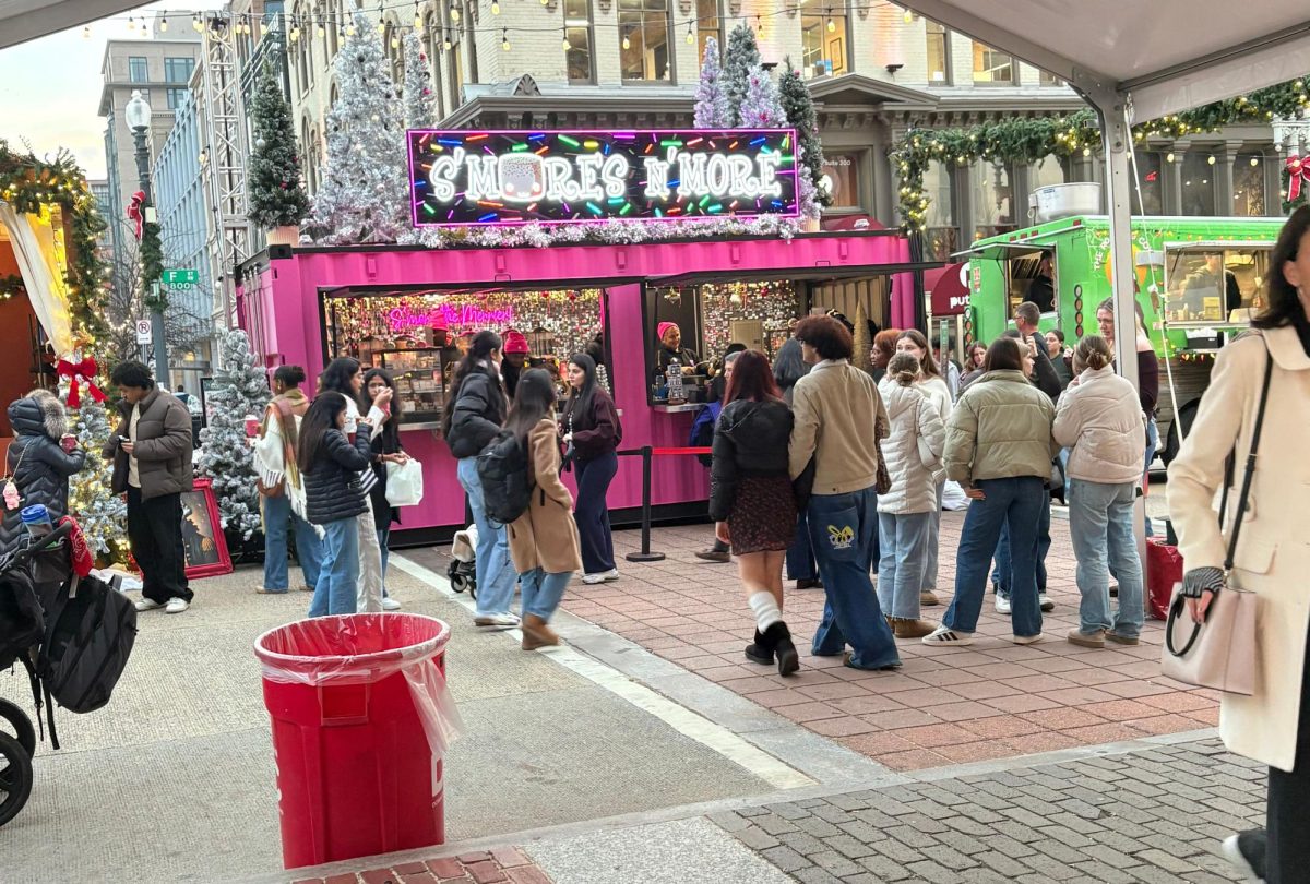 People walk through the main stretch of the market ordering winter drinks and treats. 