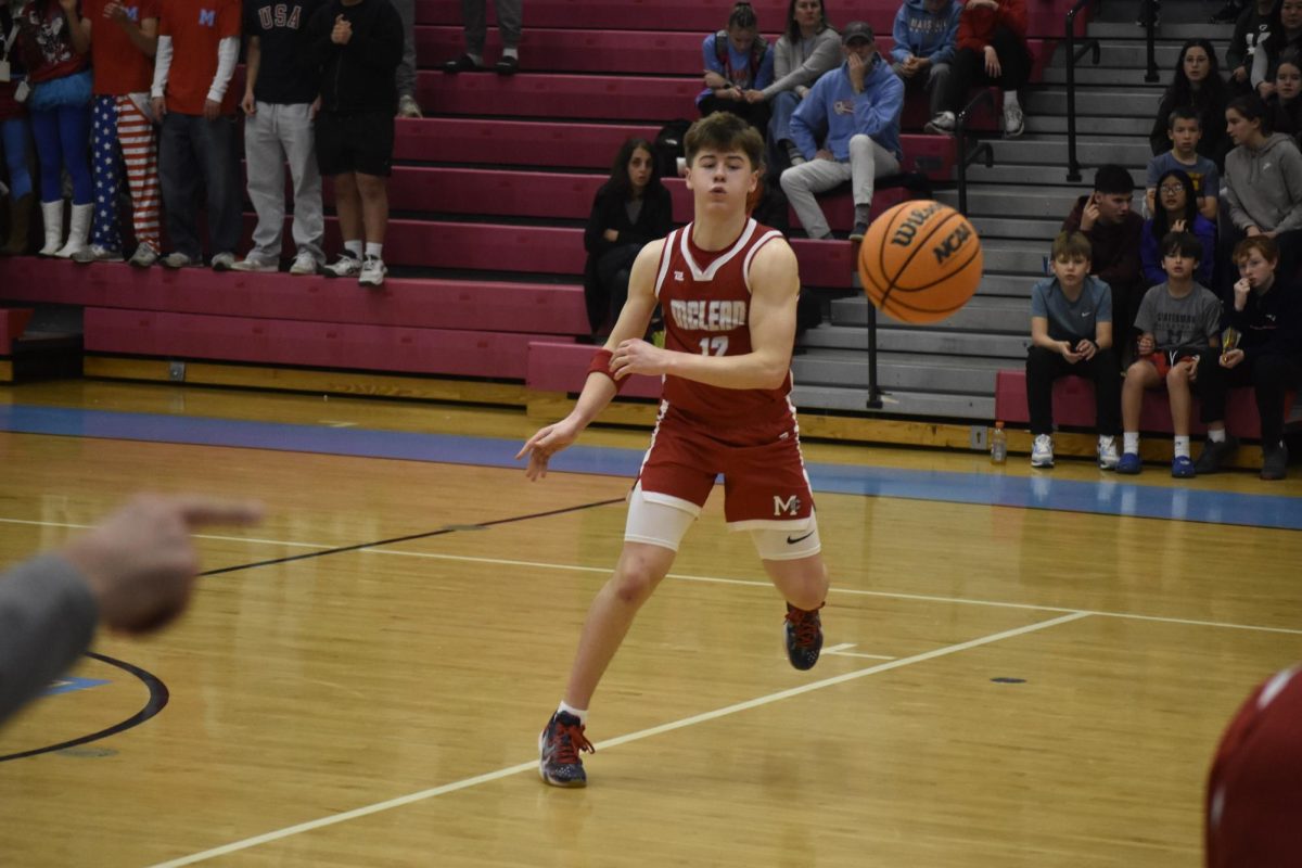 Senior Guard JW Riggins, passes the ball to an open man. JW went on to assist the game winning layup.