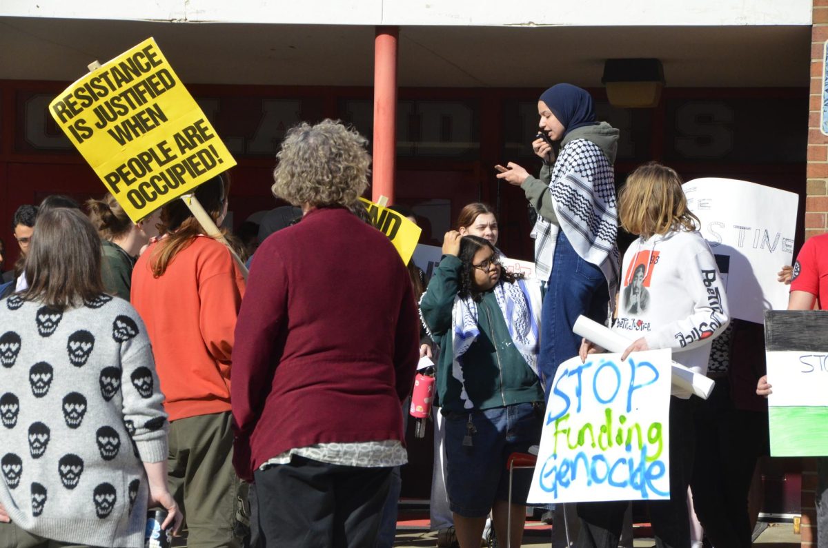Bayann Hamed speaks to protestors in 2025 anti-apartheid walkout. 