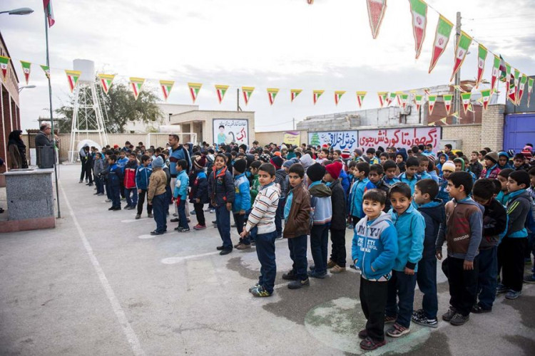 Elementary school students stand in the courtyard of a school in Iran. Every morning, students are instructed to chant, “Marg bar Amrika [Death to America], Marg bar Israel [Death to Israel].”