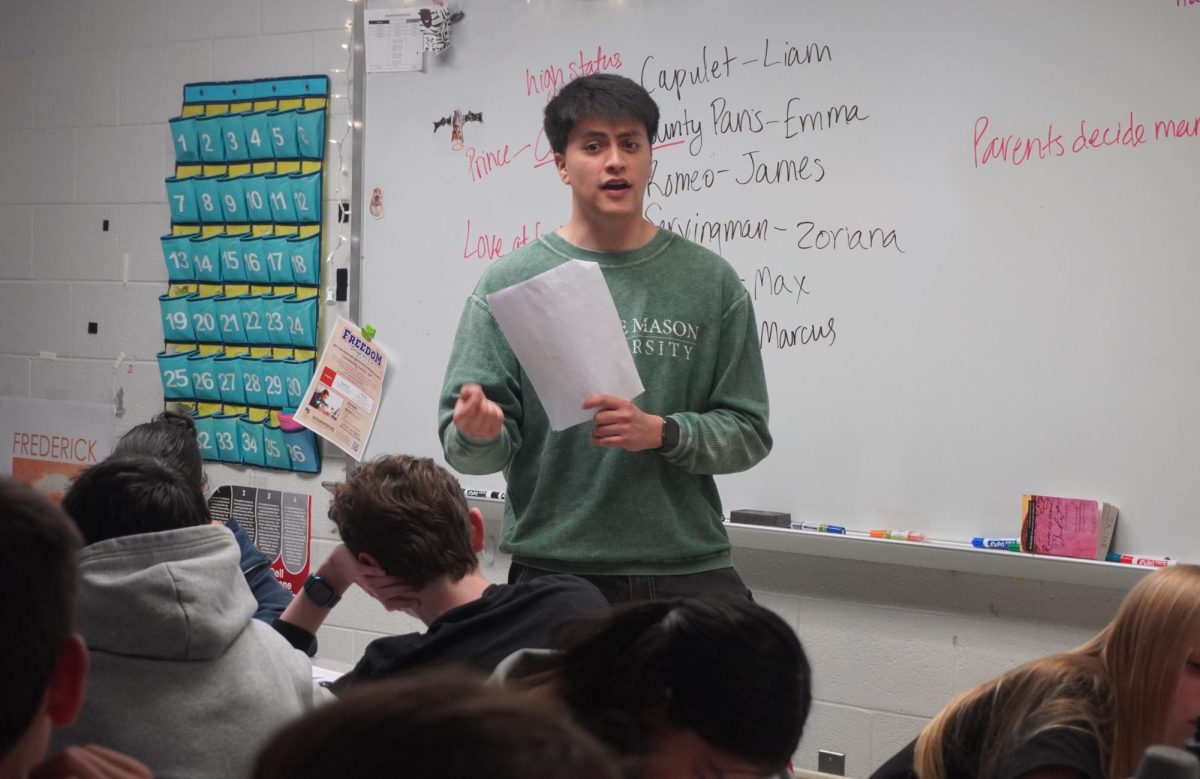 English substitute and current graduate student Karlos Coria discusses Romeo and Juliet with his English 9 class. Coria took the place of Diana Glaser in the middle of the school year, trying his best to implement his own teaching ideals.