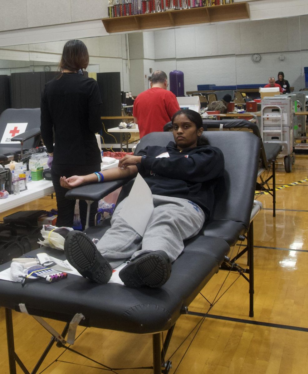 Student to the rescue-- Junior Katrina Kanthraj waits patiently after getting her blood drawn. Her contribution will be distributed to the American Red Cross Club, battling the recent blood shortage.