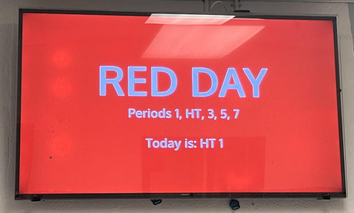The TV in the blue hallway displays the current bell schedule. This schedule will change next school year and Highlander Time will no longer occur on red days. 