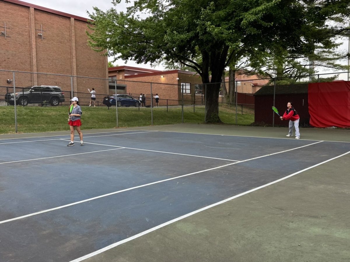 Senior Katelyn Gray gets ready to return a serve at one doubles against Marshall. Gray played very well in this match, accounting for many volley winners and forcing errors on the opponents.