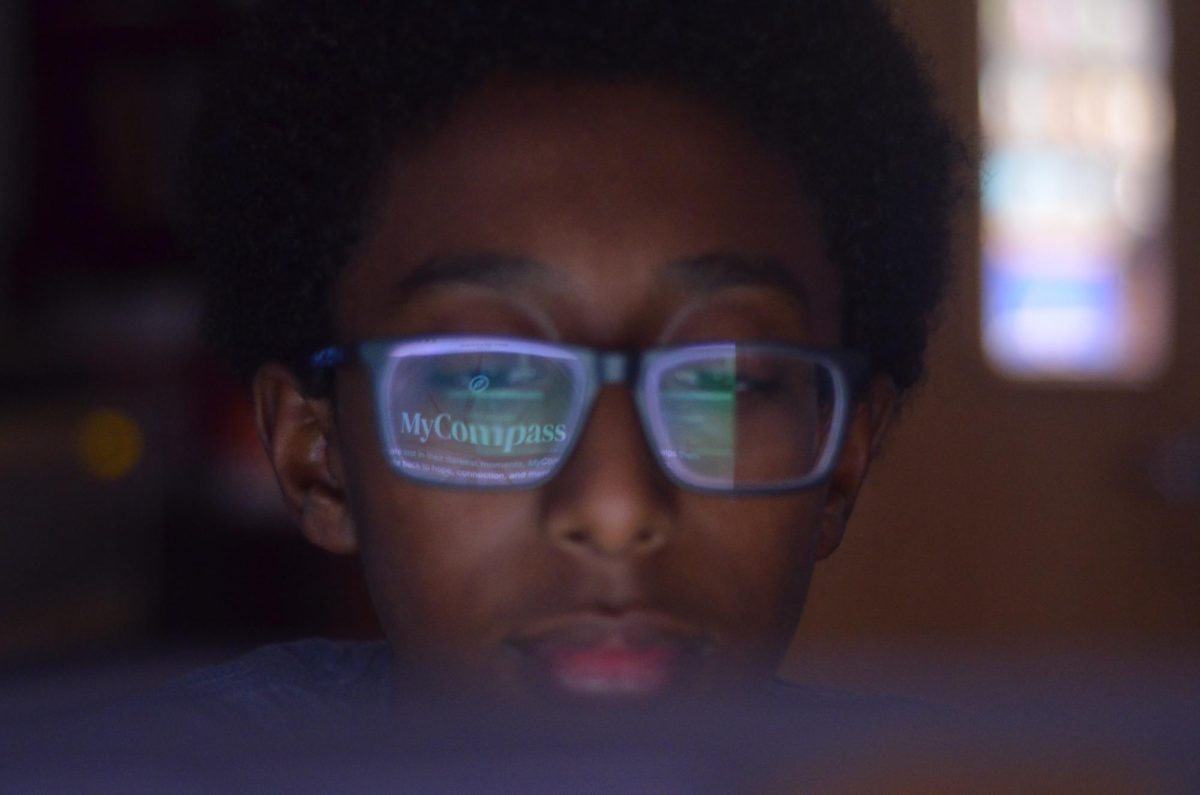 Emmanuel Beakal diligently refines MyCompass, working to perfect it as a tool to support youth mental health across FCPS. Reflected in his glasses is the MyCompass logo—its thoughtfully chosen name symbolizes the bot’s role as a guide for young users.