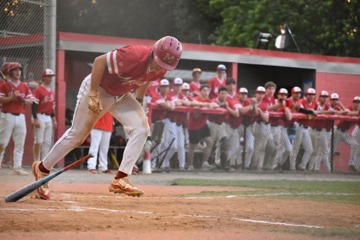 Junior third baseman Caius Antolik drops the bat and breaks toward first after putting the ball in play during the third inning. Antolik later came around to score McLean’s first run of the game.