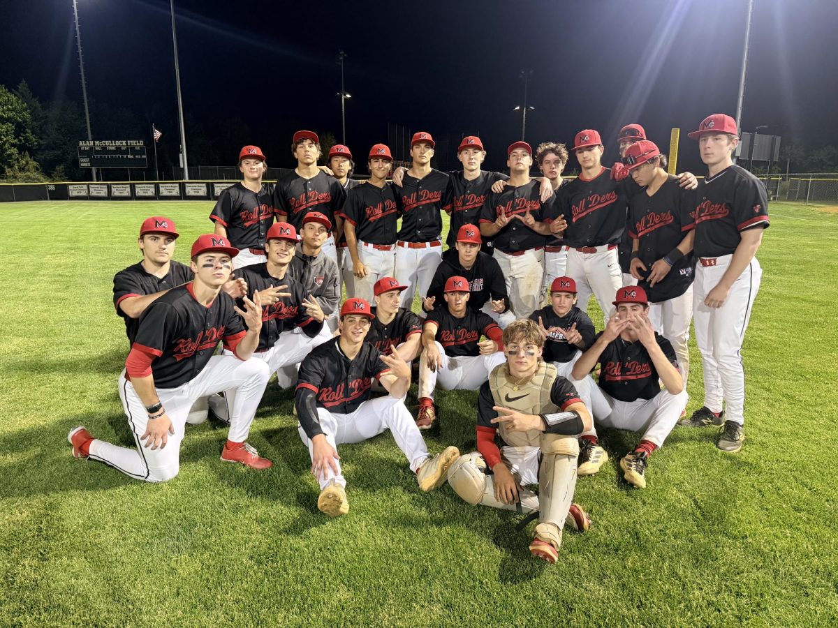 McLean Baseball poses for a celebratory picture after defeating the Herndon Hornets 8-7. The win marked the Highlanders second win over the Hornets in the same week.