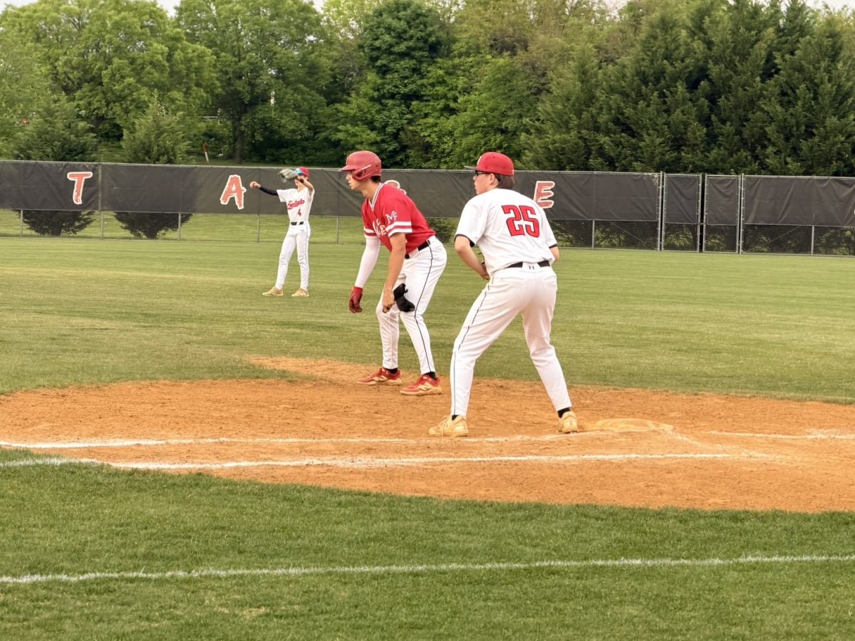 Senior left fielder Ryan Riggins takes a lead off first base. Riggins provided an RBI double for the Highlanders.