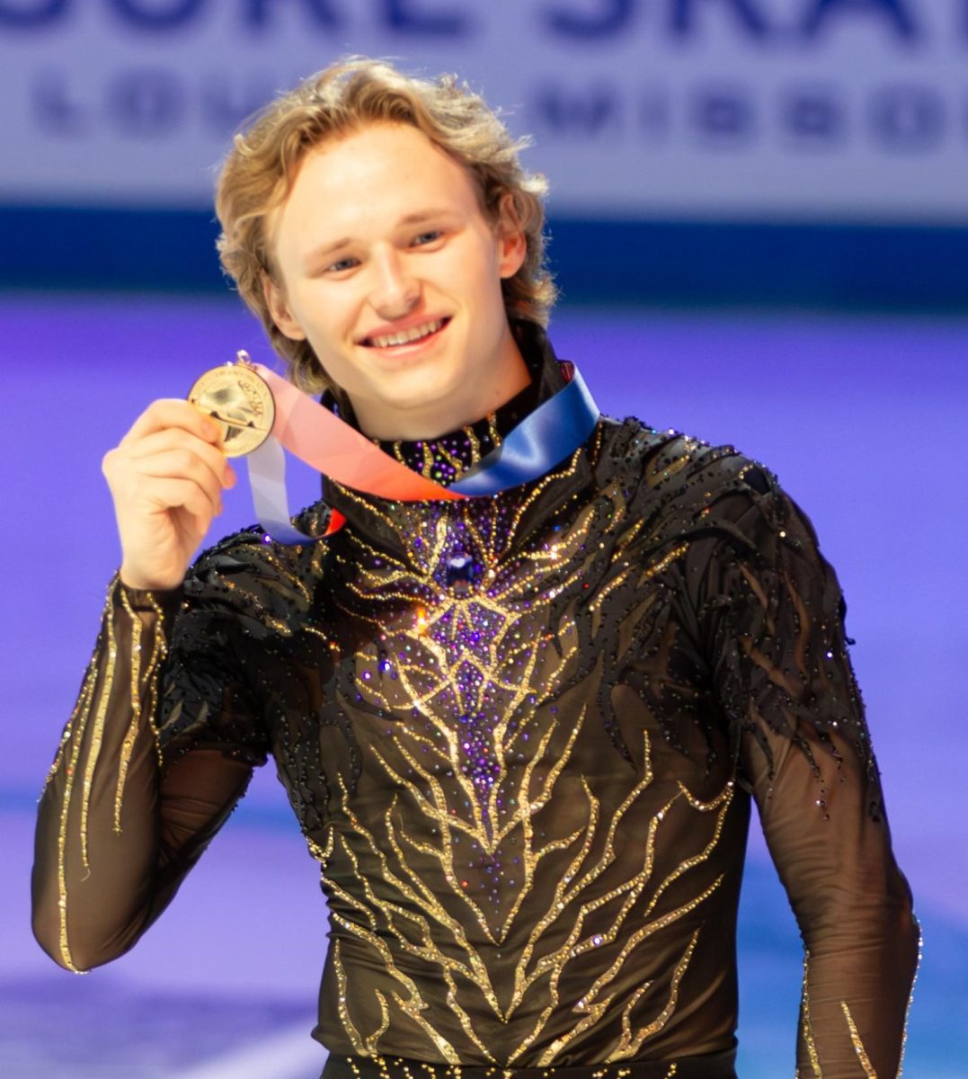 Olympian Ilia Malinin shows off the gold medal which he won for the United States figure skating in the 2026 Milan Winter Olympics. Malinin graduated from George C. Marshall High School in 2023, and pursued a career in figure skating.