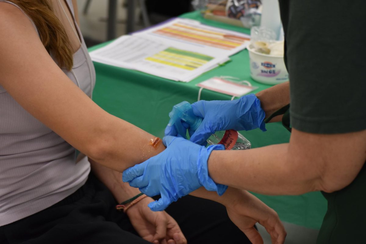 Volunteers from the Community Emergency Response Team (CERT) applying medical moulage to victims.