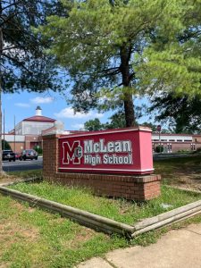 The sign for McLean High School stands in front of the school on a bright afternoon day. At the time of this photograph school had been out for just over 2 weeks, and the month of June was almost over.