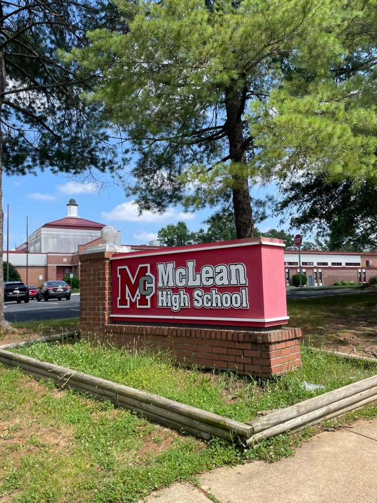 The sign for McLean High School stands in front of the school on a bright afternoon day. At the time of this photograph school had been out for just over 2 weeks, and the month of June was almost over.  
