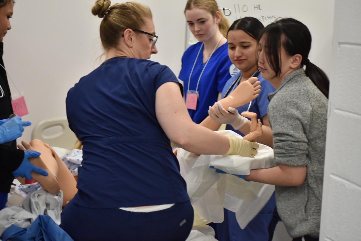 Students supporting a patient in childbirth.