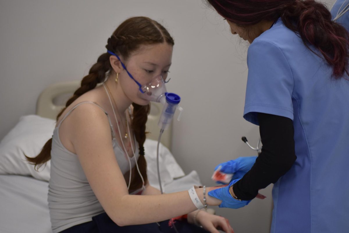 Student cleaning patient's wounds.