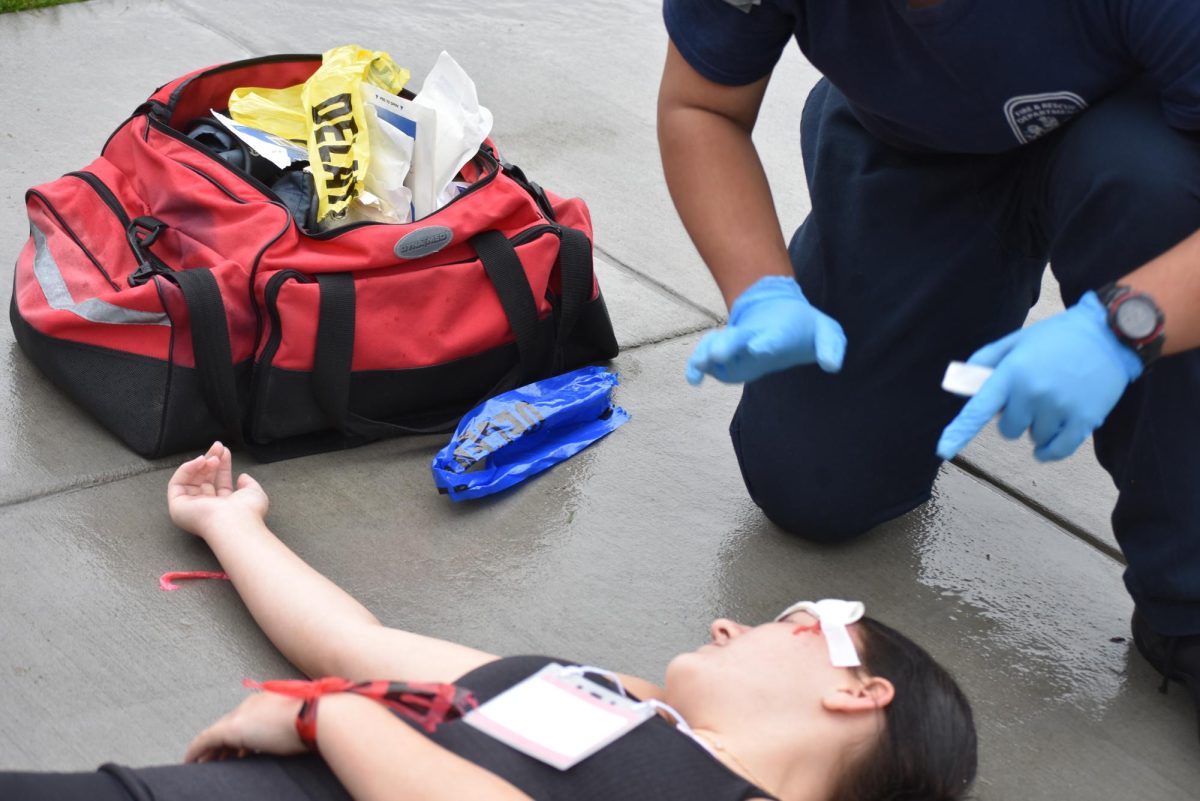 EMT student triaging victim and providing initial emergency care.