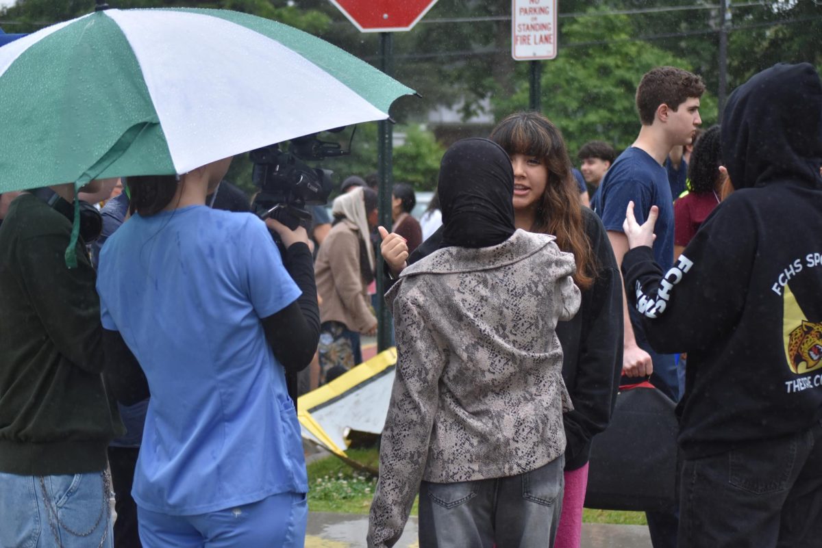 Witness describing the scene to mock reporter alongside ASL interpreter.