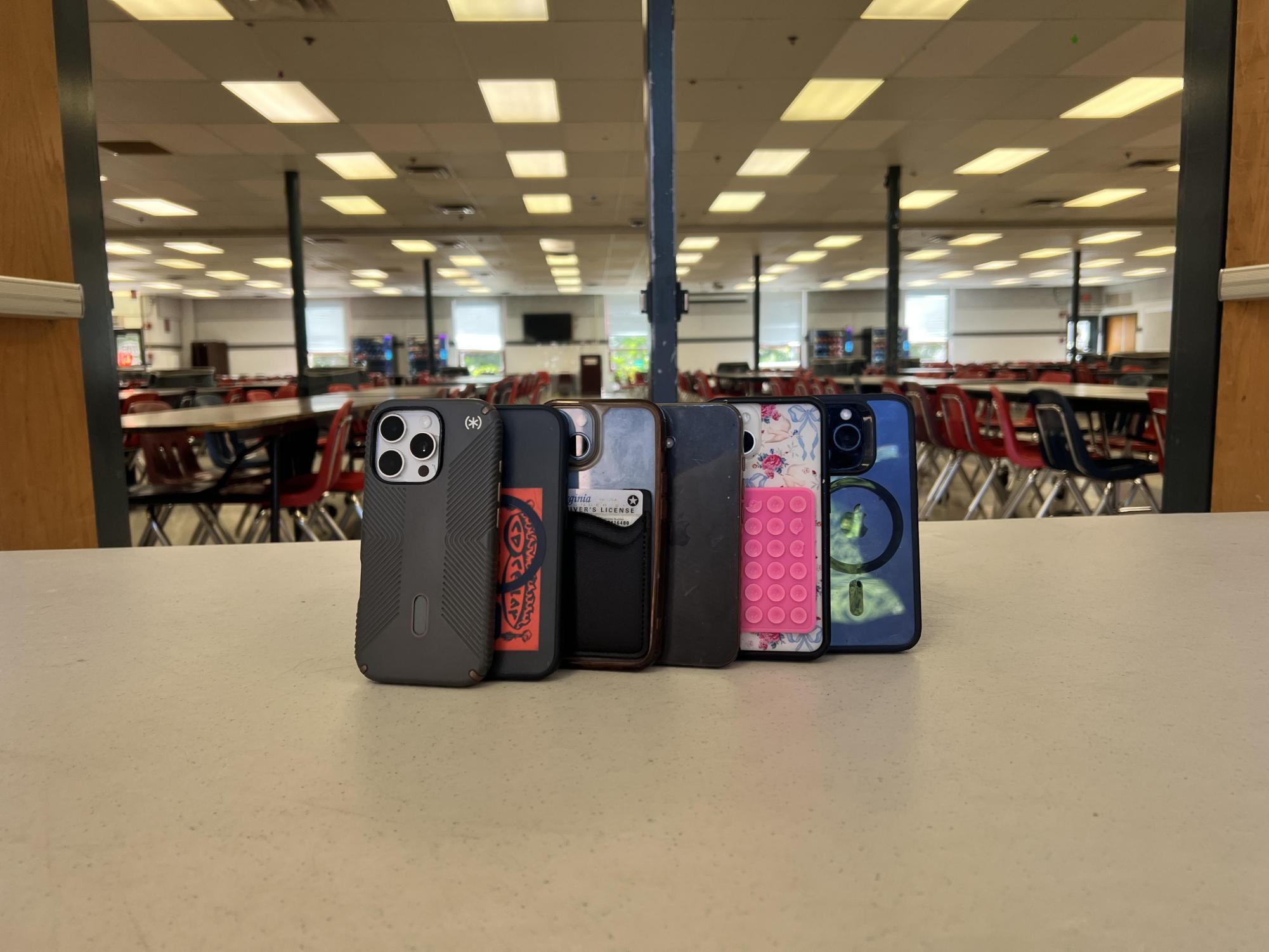 Phones rest on the entrance to the cafeteria, representing that phones wont be allowed for lunch next year.  Phones will not be allowed bell to bell next year due to the policy.